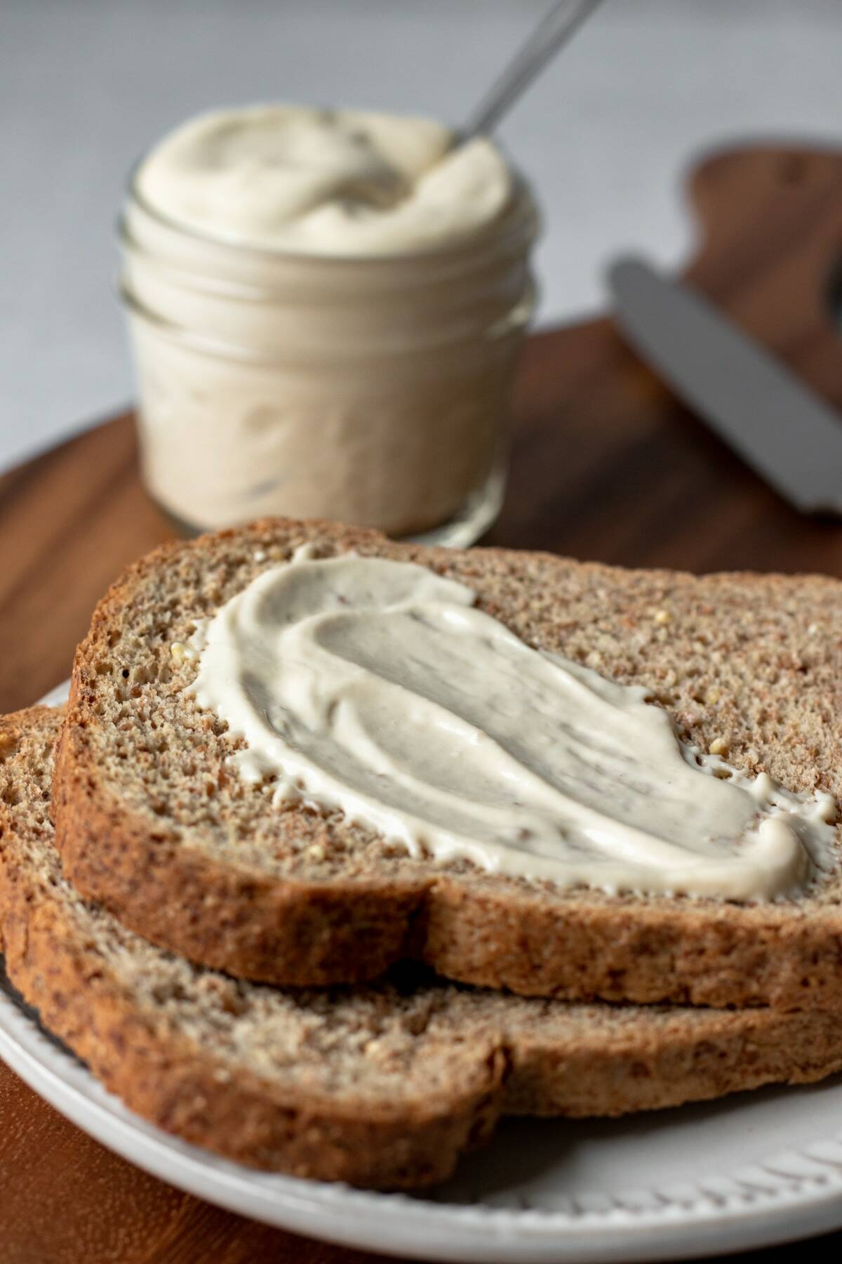 aquafaba mayo spread on a piece of toasted bread.