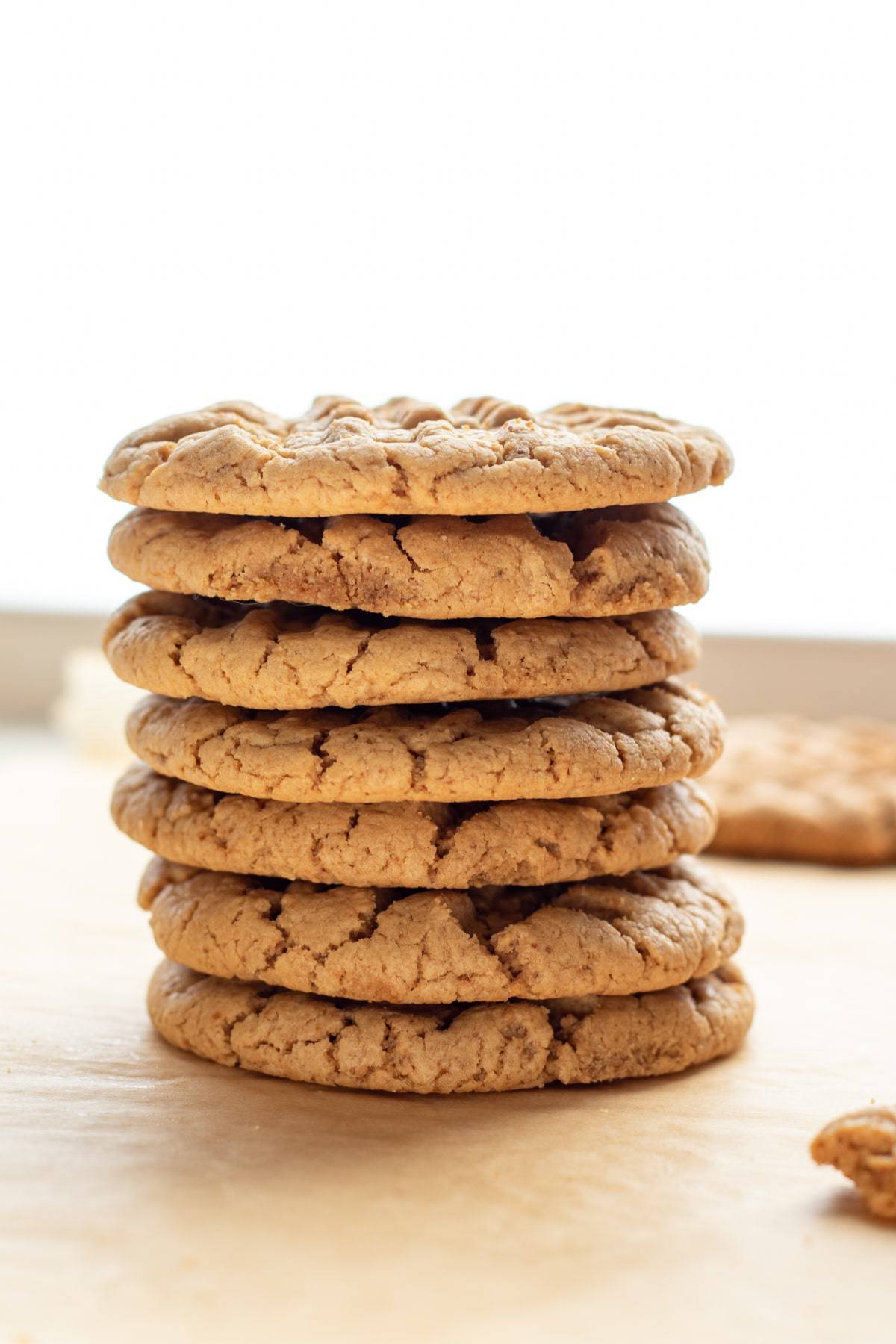 backlit photo of a stack of 7 gluten free peanut butter cookies.