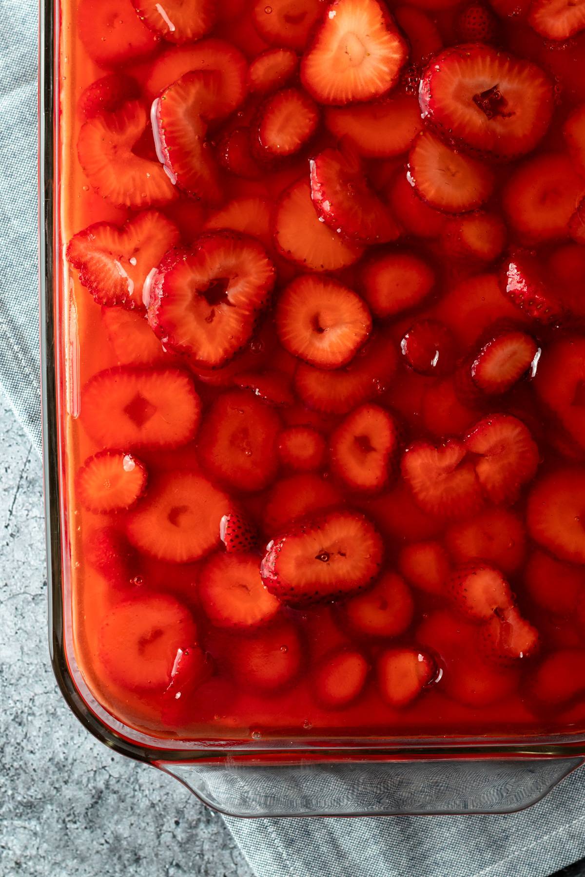 overhead close up of strawberry pretzel salad in a glass dish.