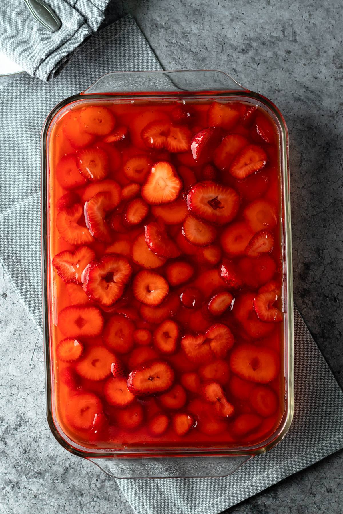 overhead view of vegan strawberry pretzel salad in a glass casserole dish.