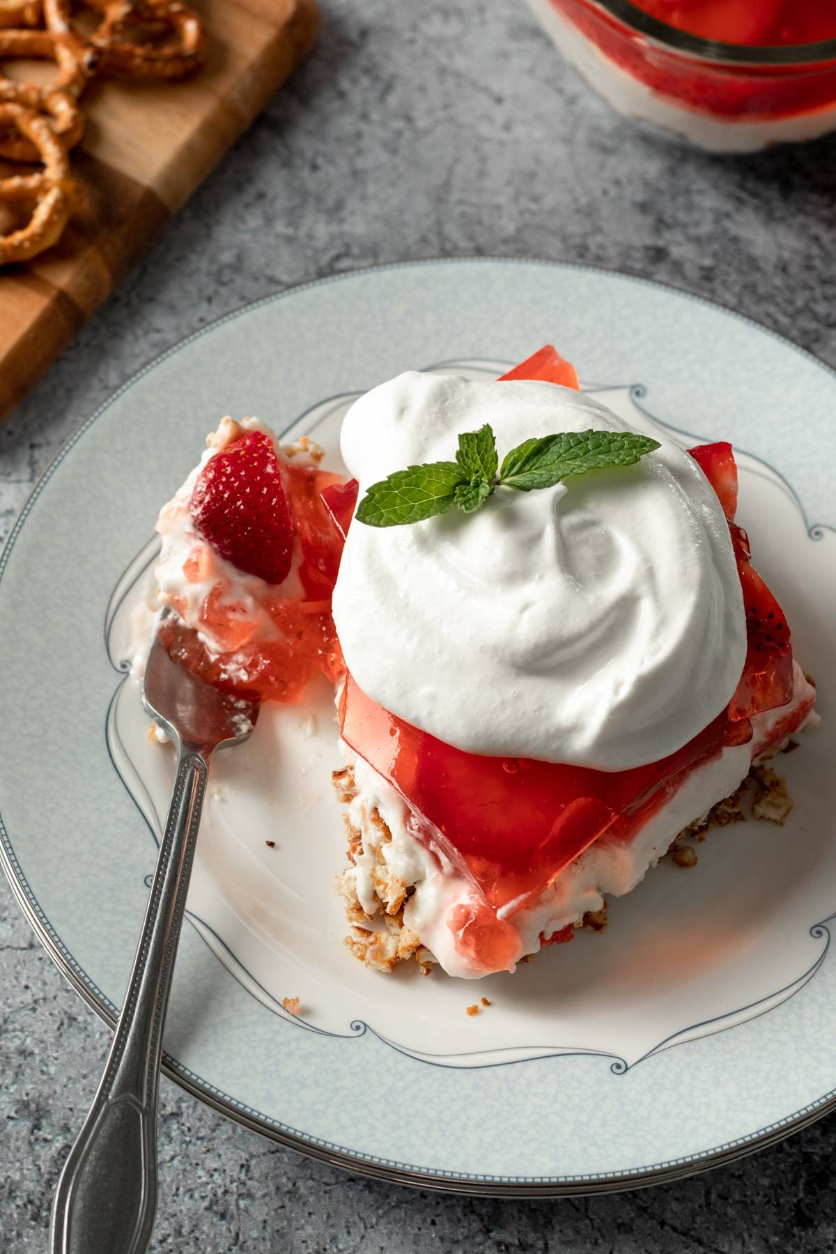 a serving of vegan strawberry pretzel salad on a plate.