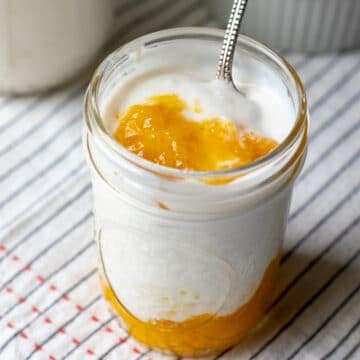 yogurt and mango puree layered in a small jar