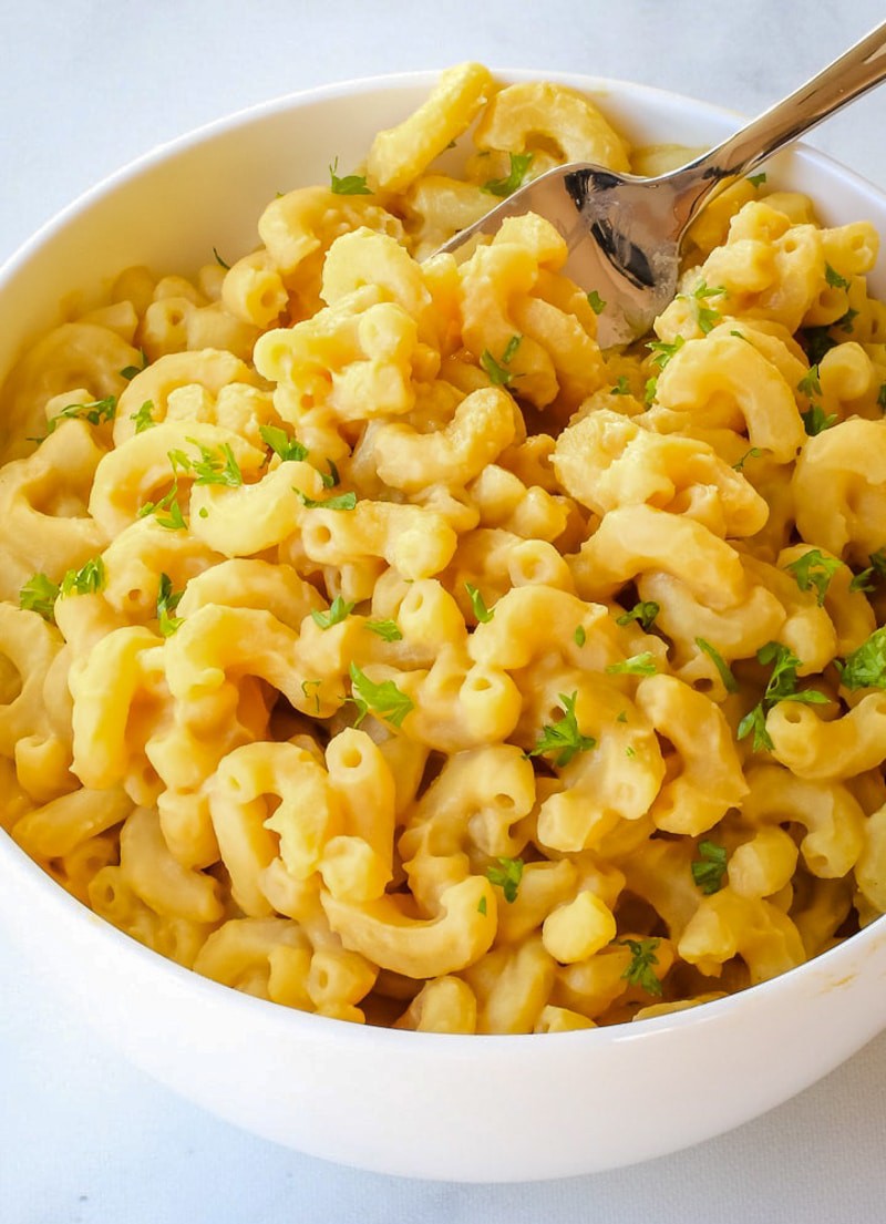 close up of chickpea mac and cheese in a white bowl.