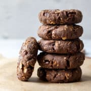 a stack of healthy protein cookies on parchment paper.