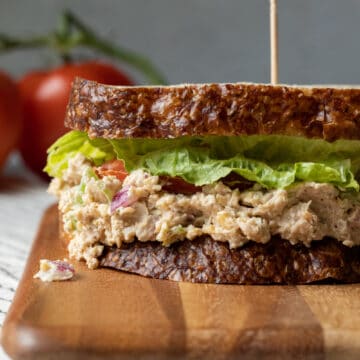 side view of vegan tuna salad sandwich, made with chickpeas and jackfruit, red onion, celery