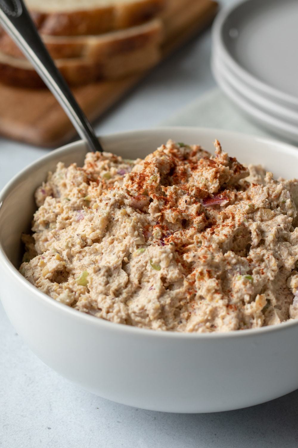 vegan tuna salad in a white bowl sprinkled with paprika.