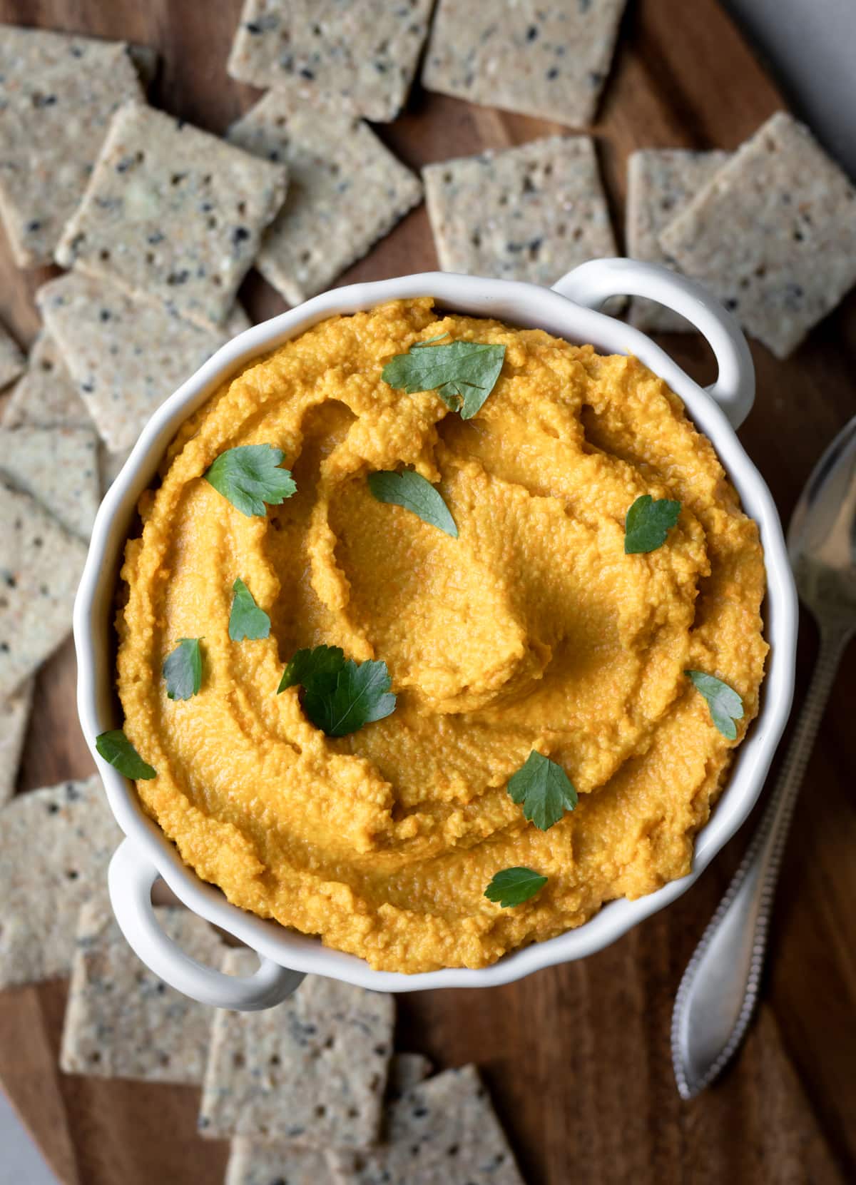 overhead view of orange-colored carrot hummus.