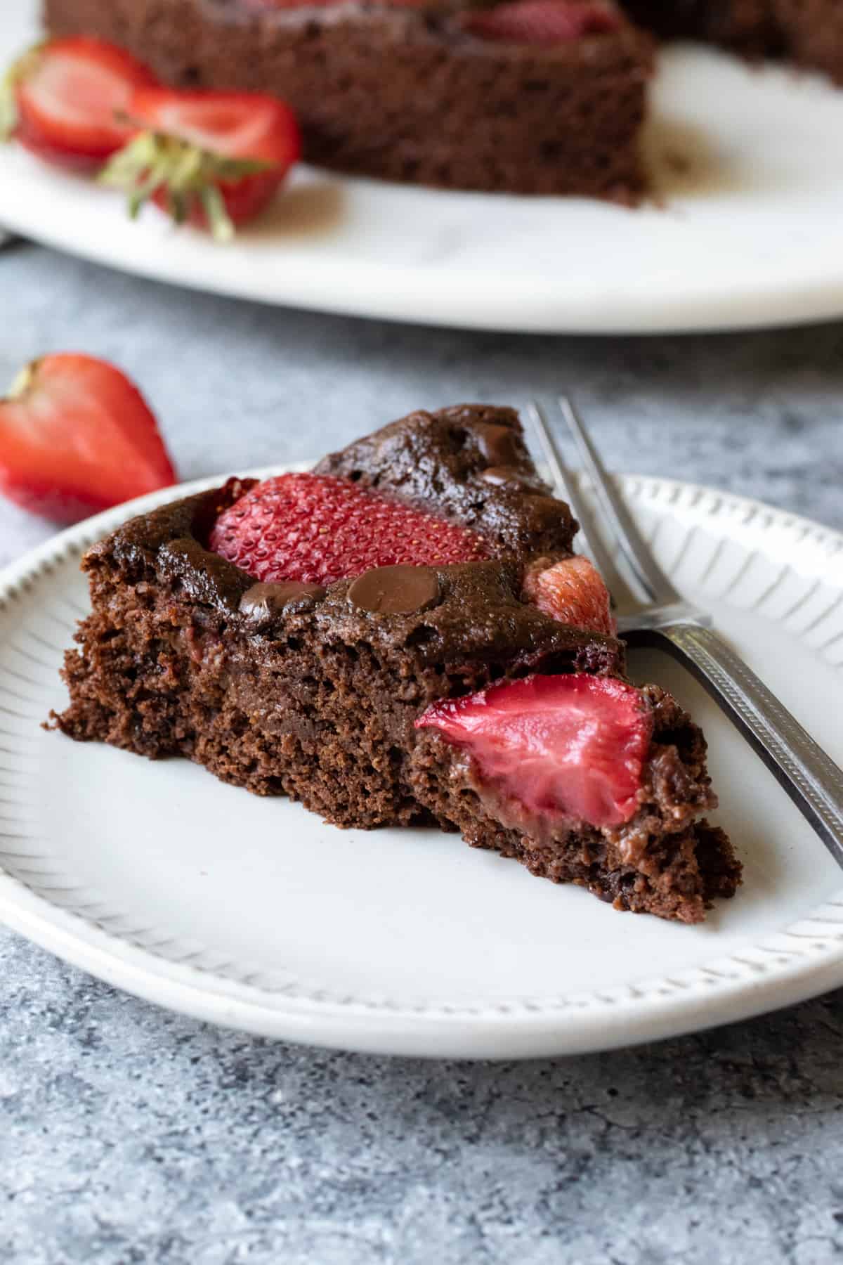 a slice of chocolate chip strawberry cake on a plate