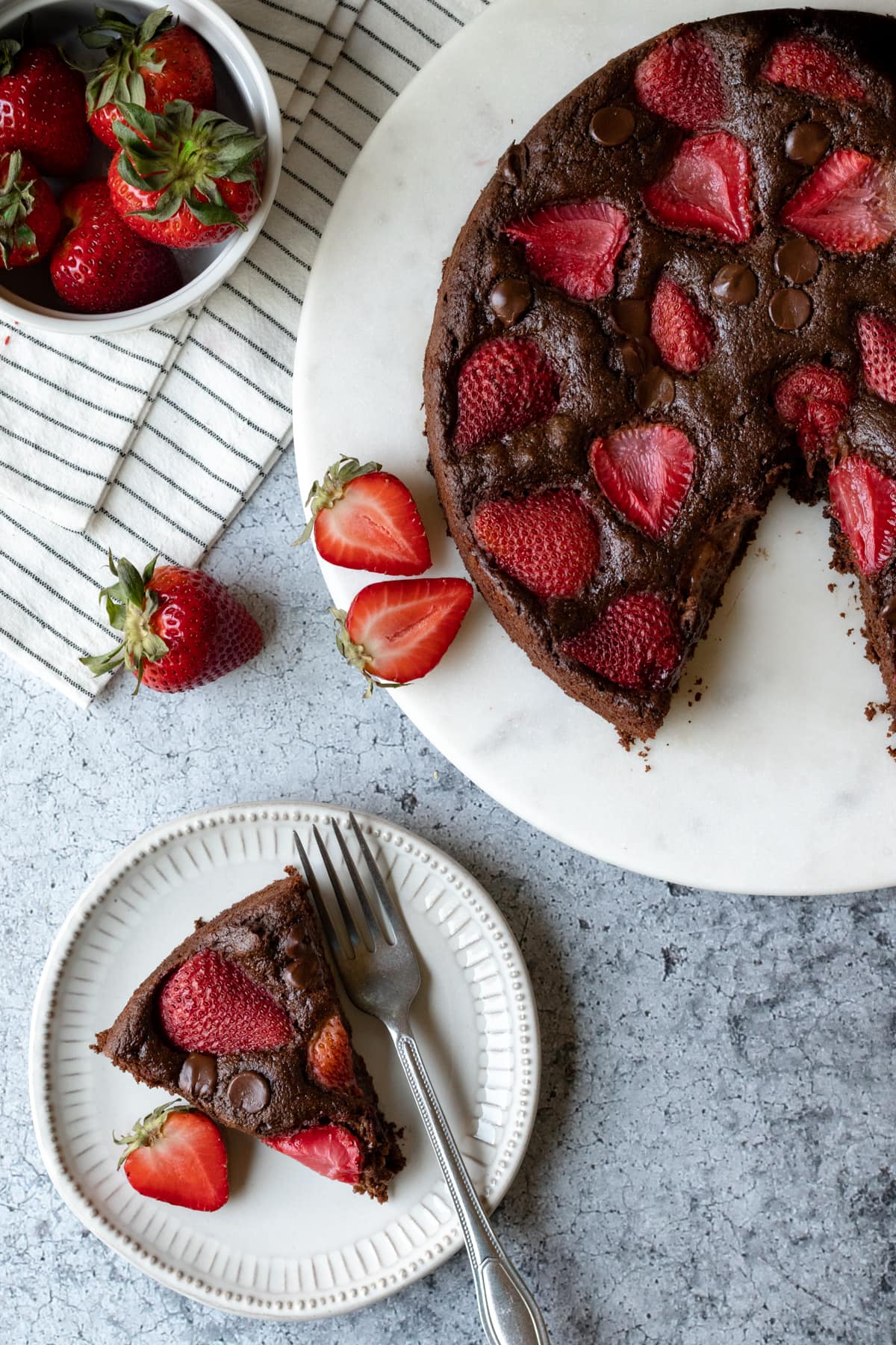 overhead view of cake with a slice on a plate