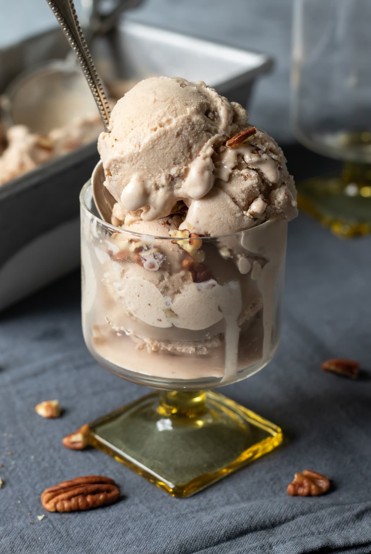 3 scoops of pecan ice cream in a sundae glass