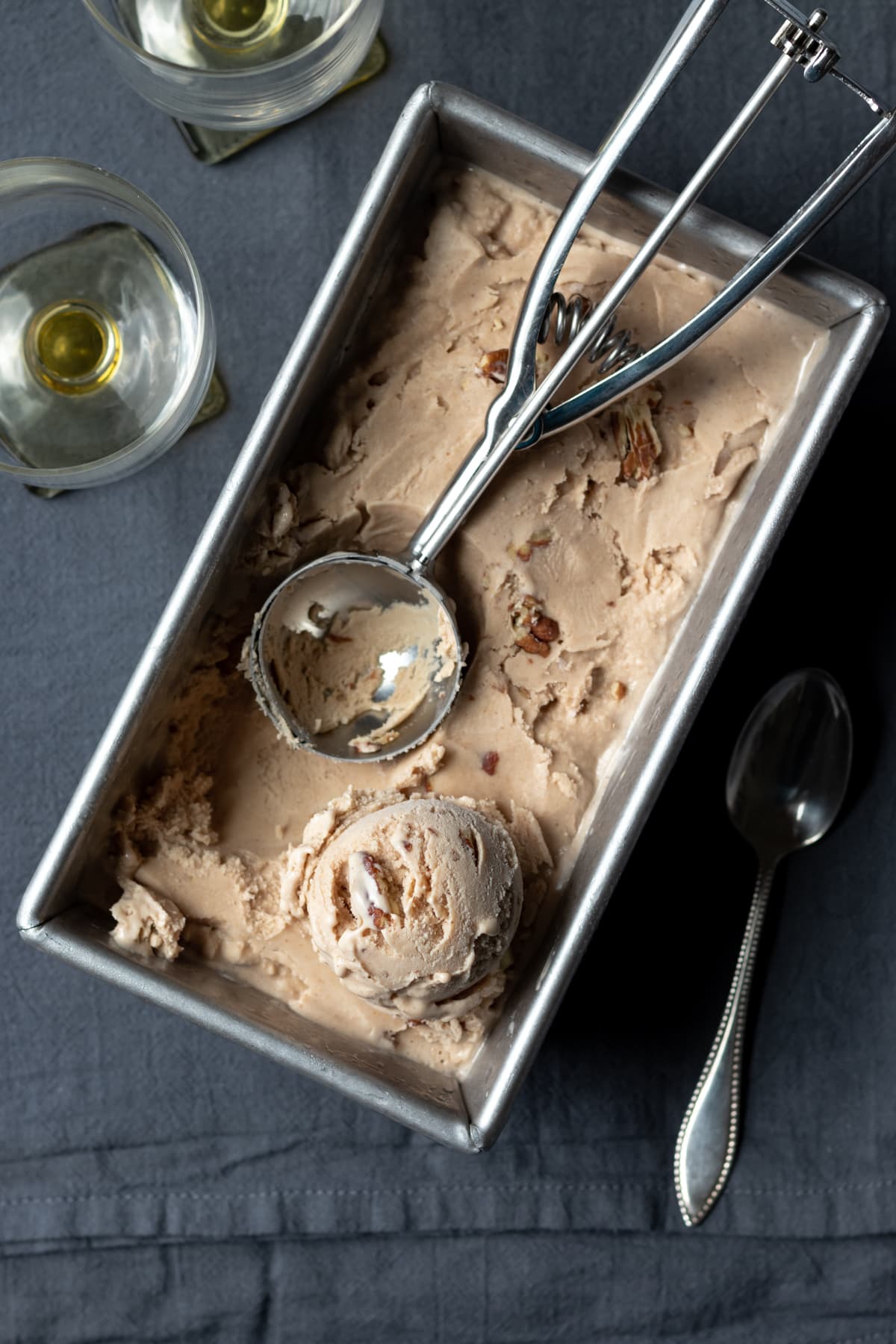 overhead shot of ice cream in a loaf pan with a scoop