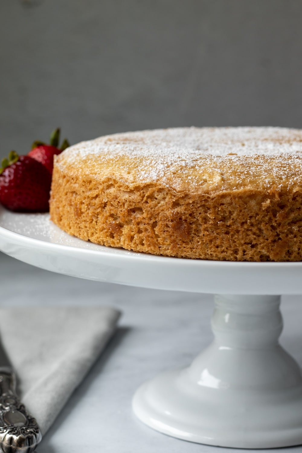 single layer yogurt cake on a cake stand.