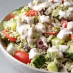 close up of orzo salad drenched with creamy olive dressing.