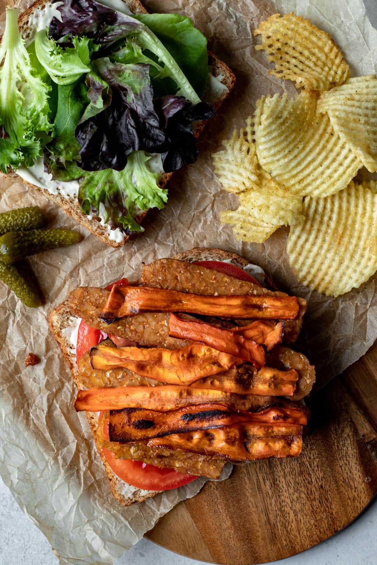 Open face BLT showing carrot bacon on top of tempeh.