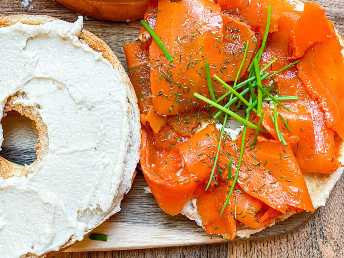 carrot lox, topped with herbs, plus cream cheese on a bagel.