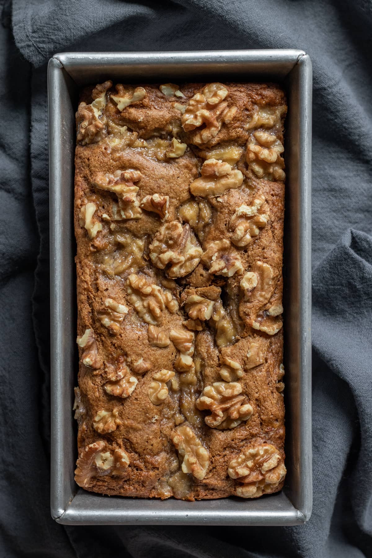 overhead view of banana bread in a metal loaf pan.