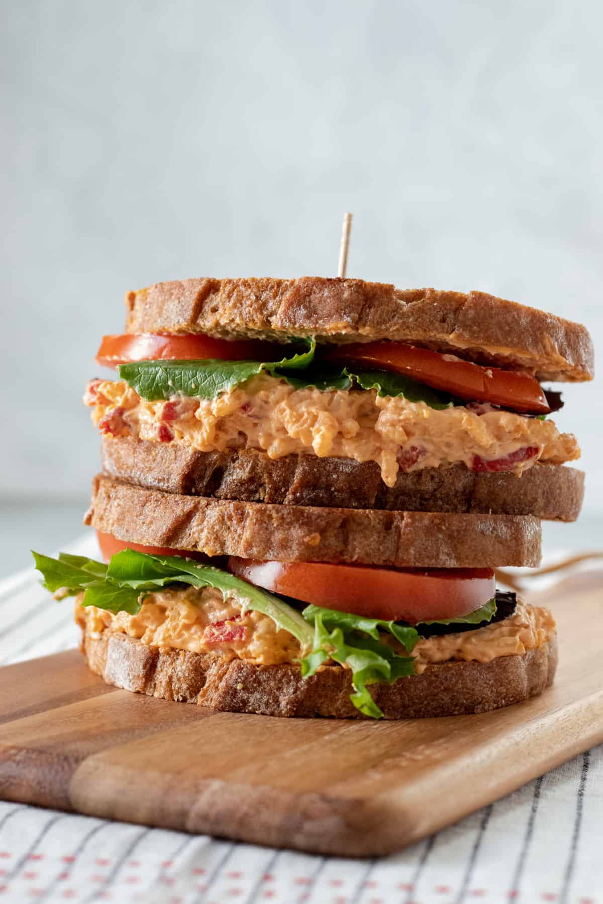 two vegan pimento cheese sandwiches stacked.