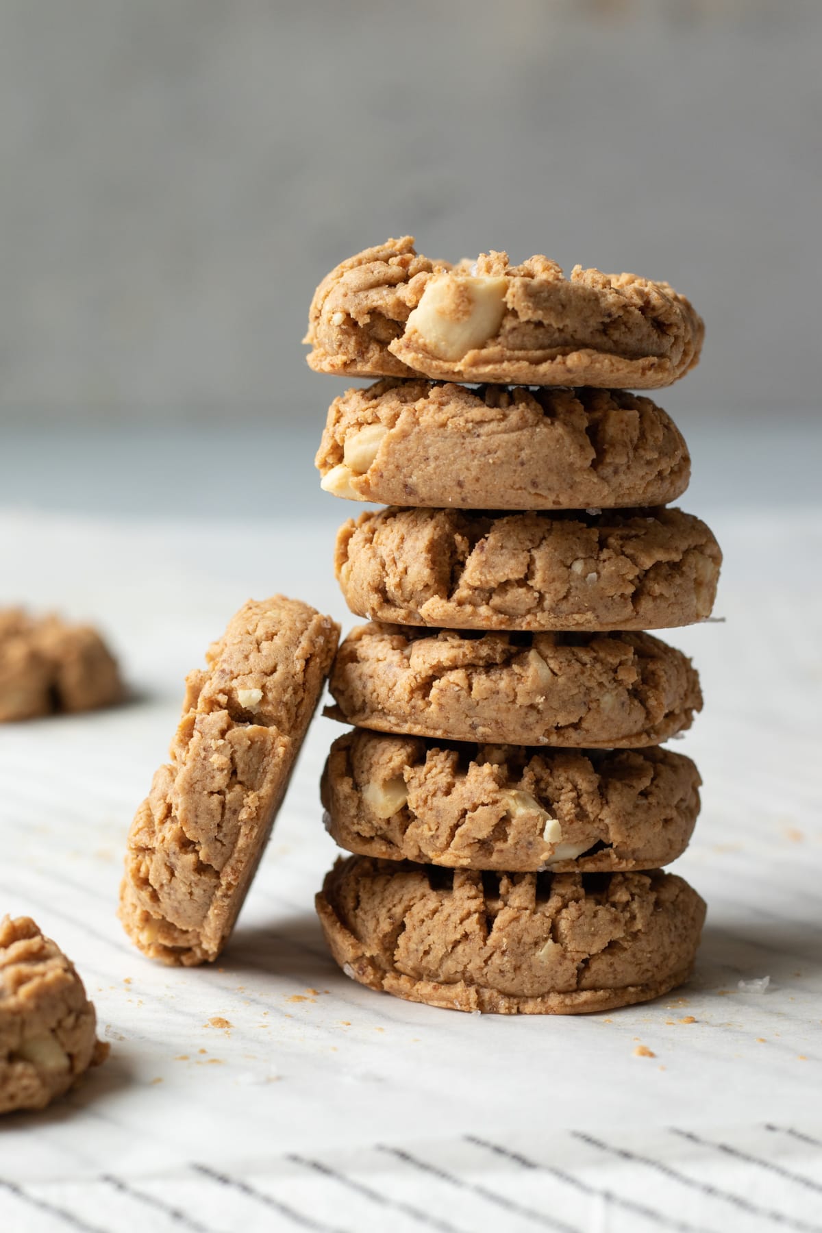 A stack of 6 small cashew butter cookies.