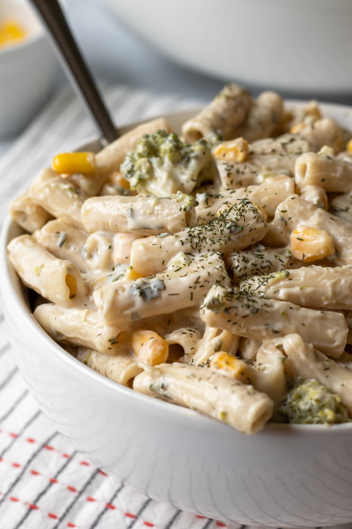 close up of ranch pasta with corn and broccoli sprinkled with dill