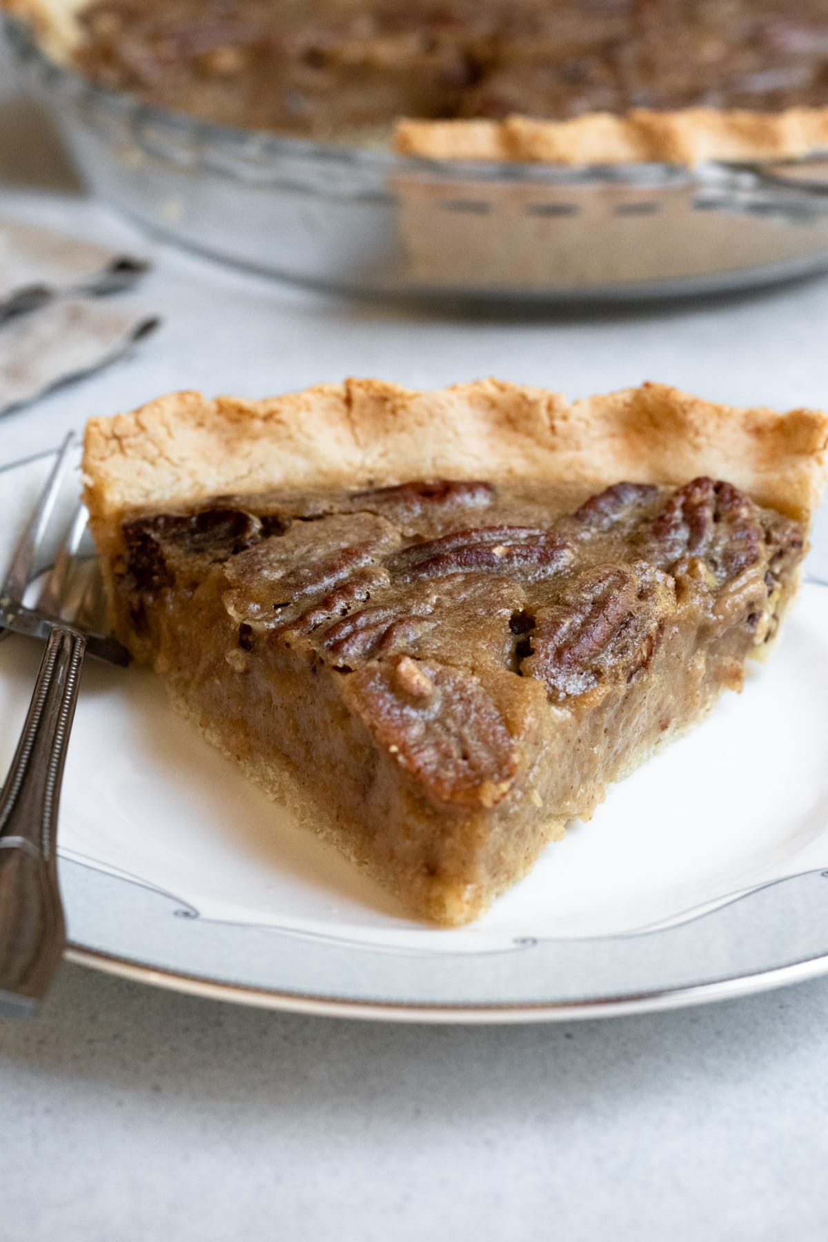 A slice of maple pecan pie on a plate.