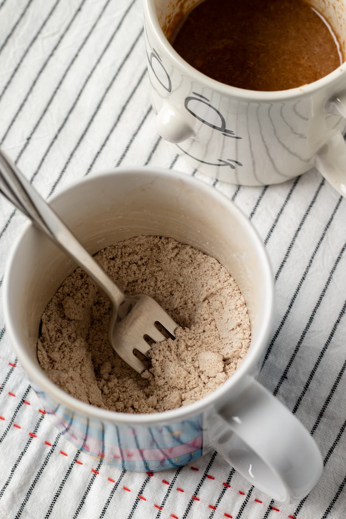 stirring together dry ingredients in a mug.