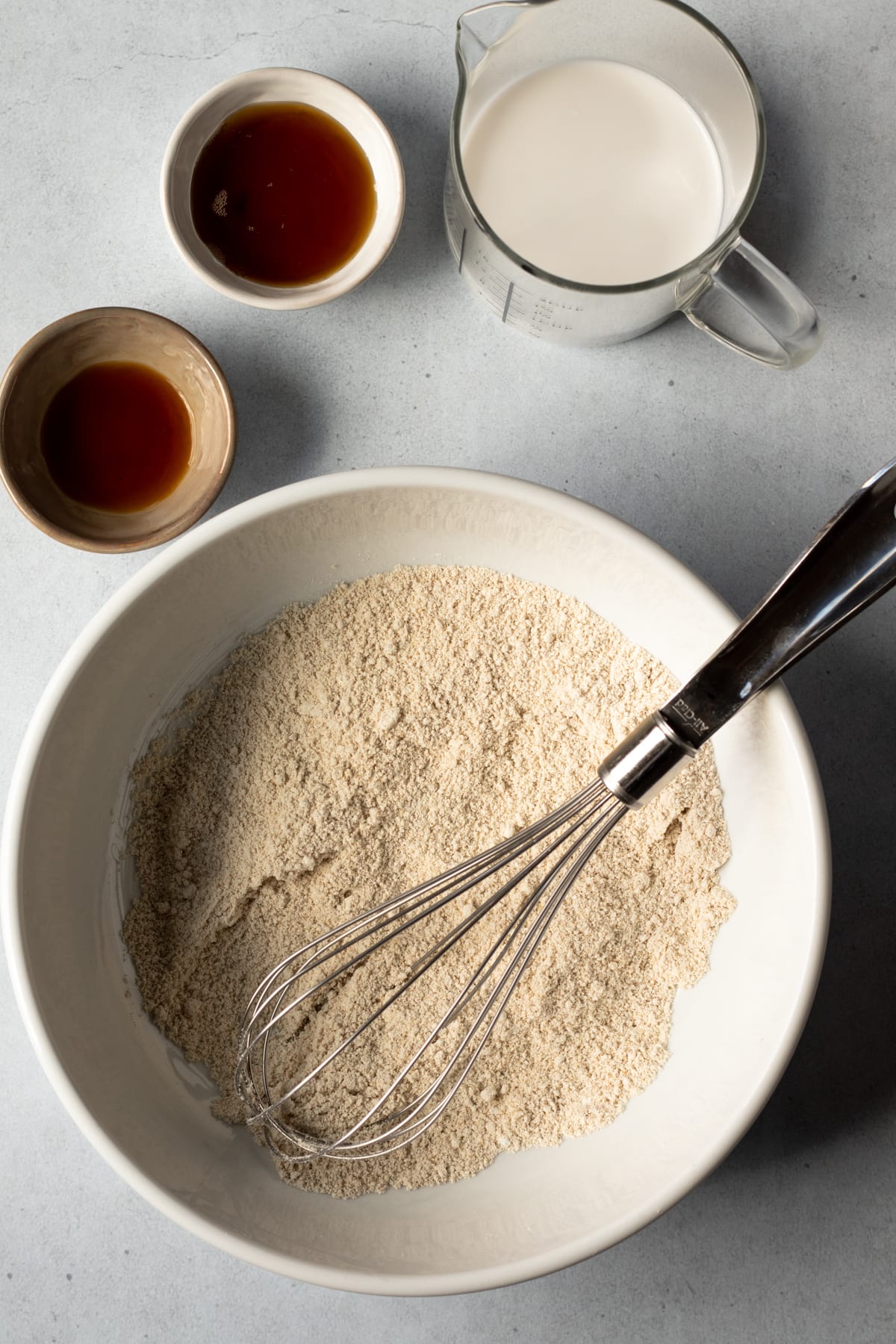 dry ingredients in a large bowl plus coconut milk, maple syrup, and vanilla.