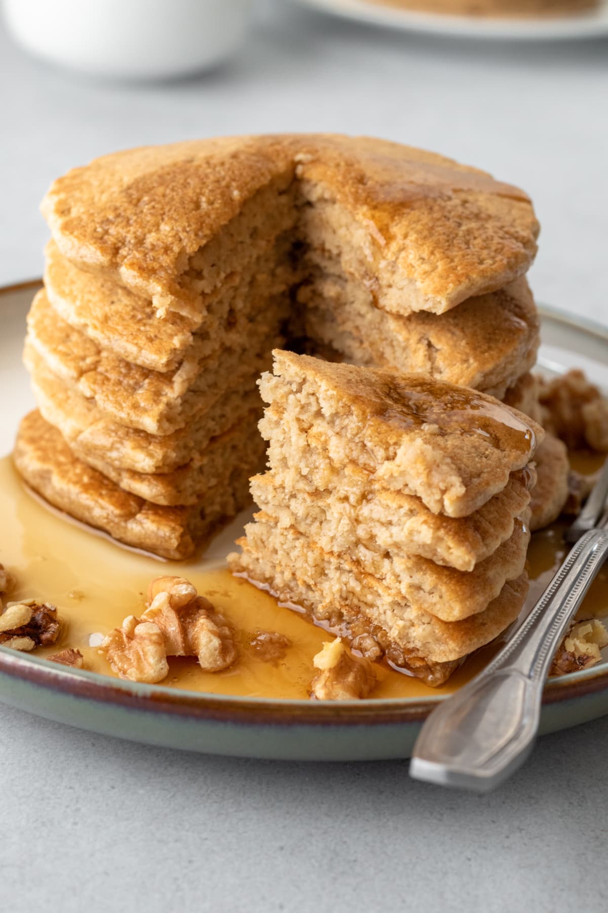 slice cut out of a pile of pancakes showing fluffy middles.