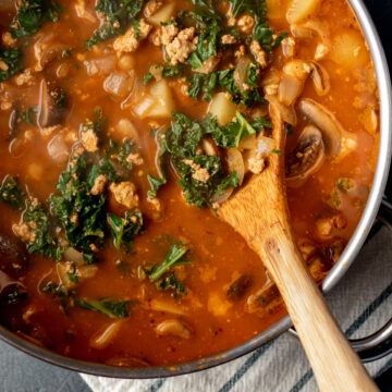 wooden spoon in soup in a pot