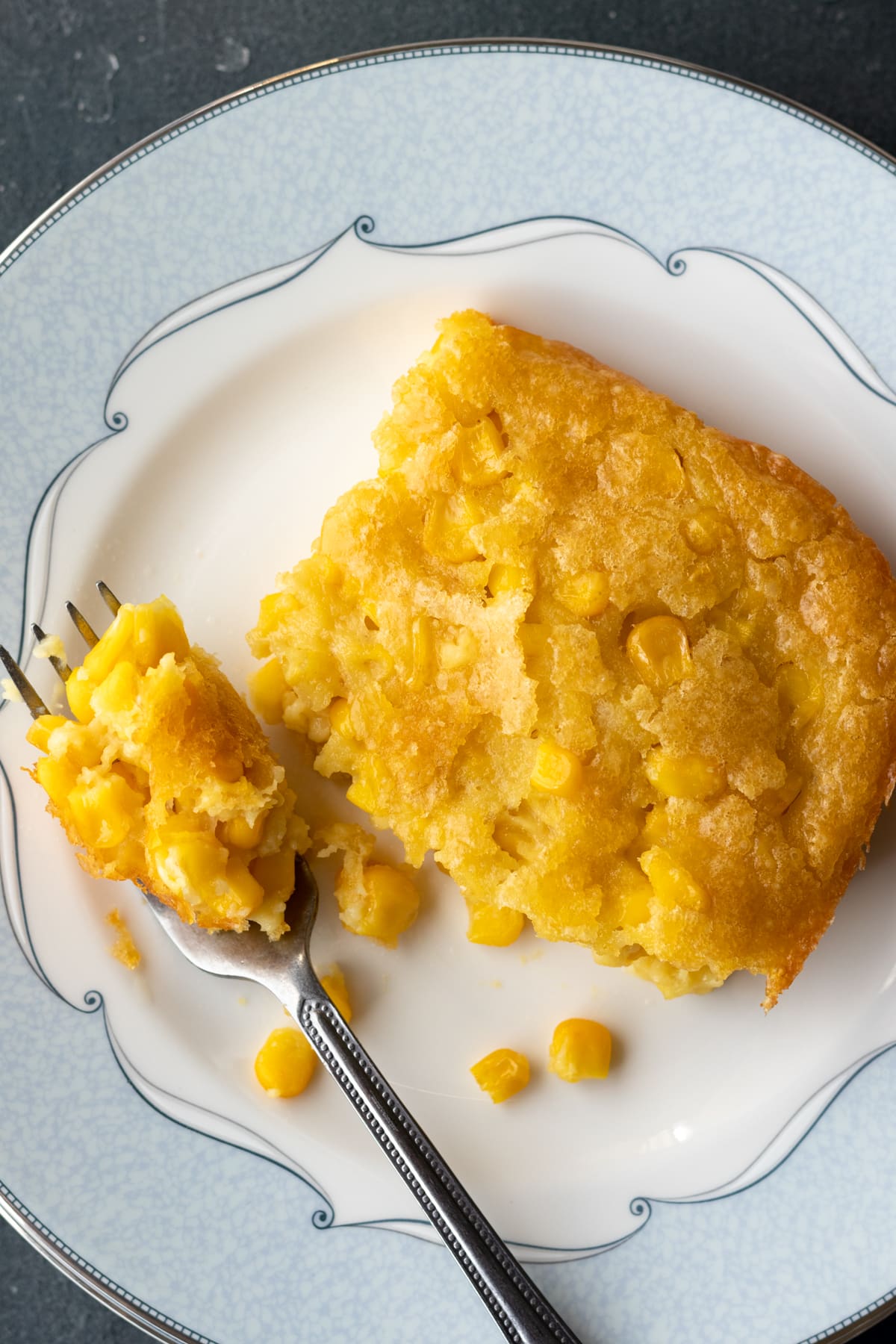 A slice of corn pudding on a plate.