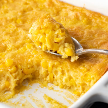 creamy corn pudding in a white baking dish.