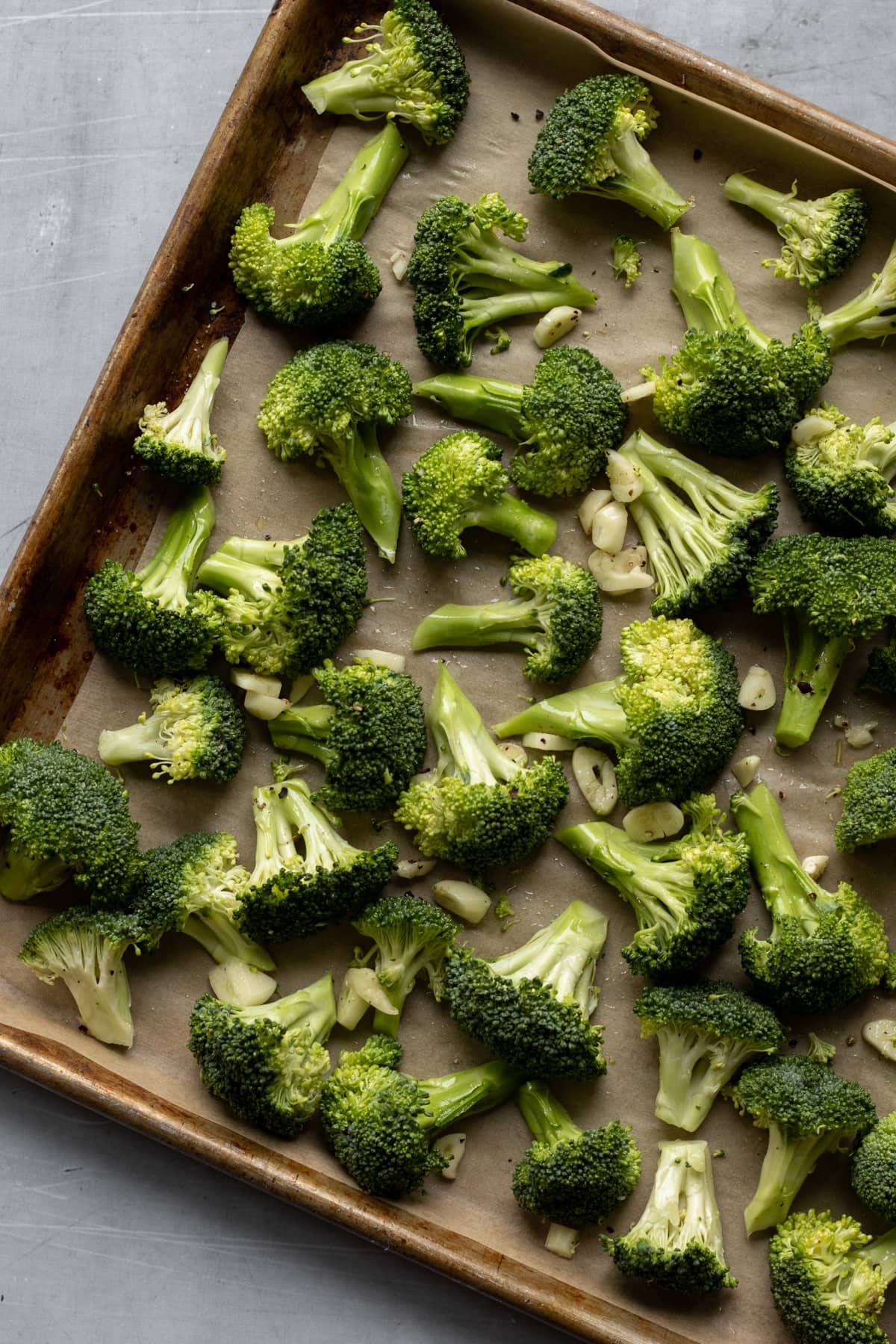broccoli florets cut and spread on a baking sheet.