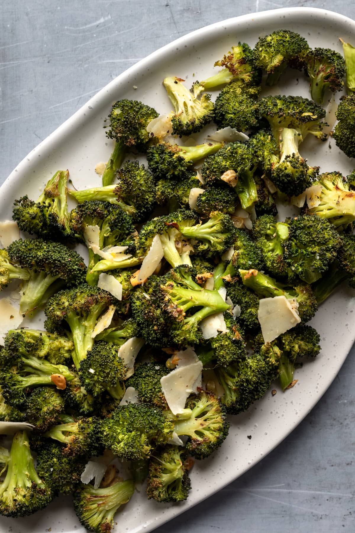 roasted broccoli on a serving platter with garlic and parmesan.