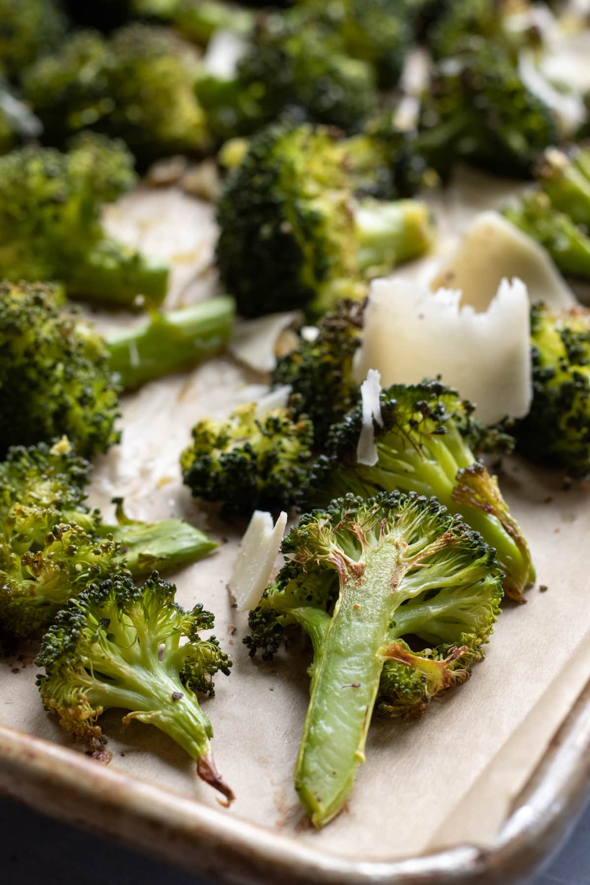 close up of roasted broccoli on sheet pan