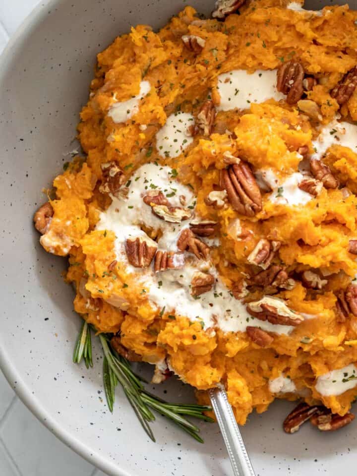 creamy sweet potato mash in a bowl with pecans and yogurt