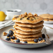 stack of healthy pancakes with blueberries and maple syrup