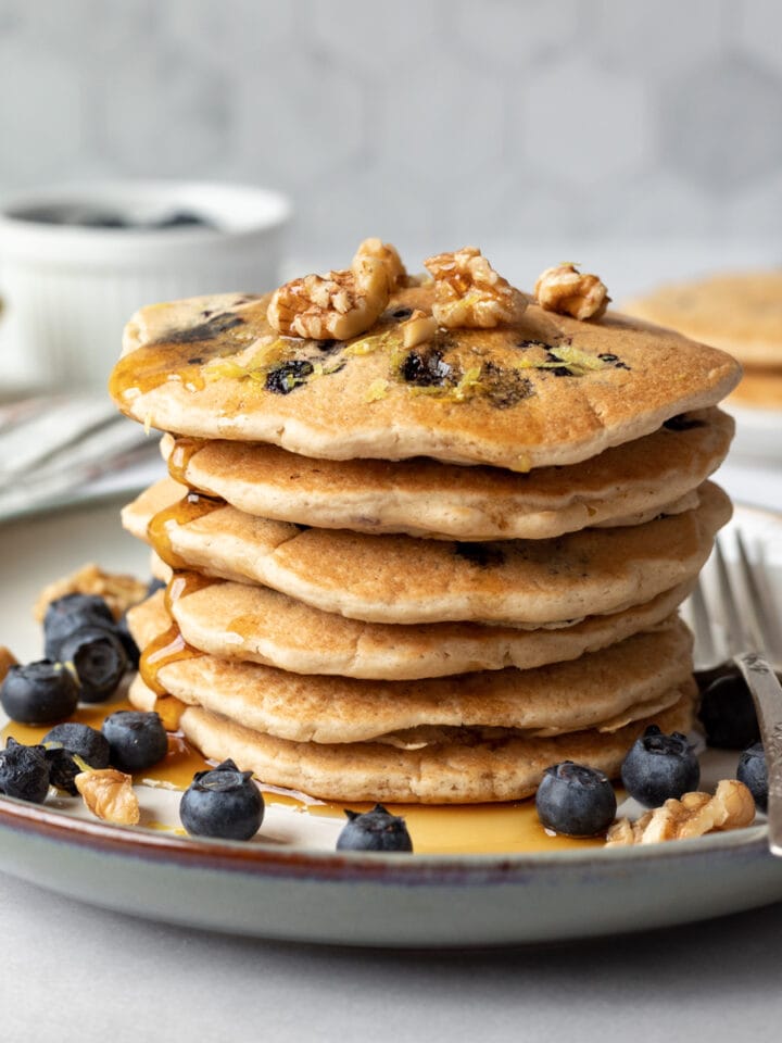 stack of healthy pancakes with blueberries and maple syrup