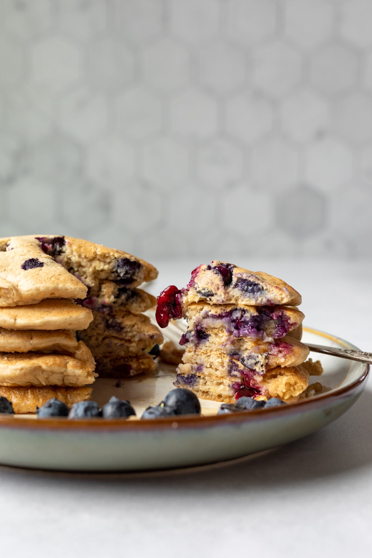 wedge of pancakes cut showing the fluffy interior texture.