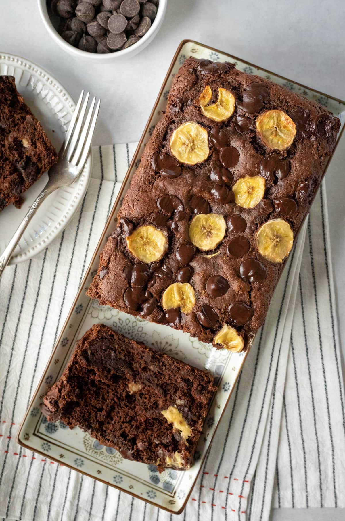 overhead view of chocolate loaf with banana slices baked into the top.