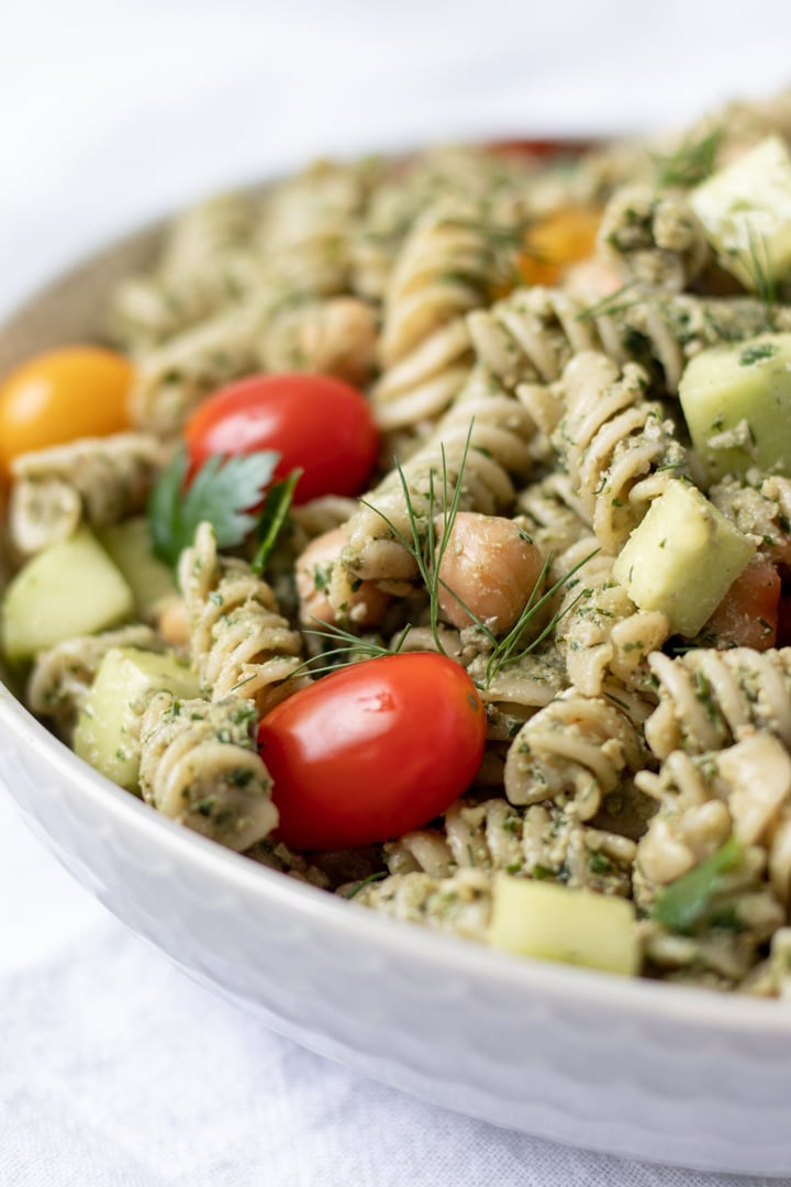 Whole-wheat spiral pasta salad coated with pesto.