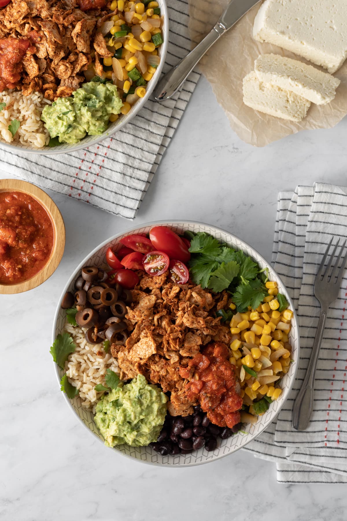 overhead view of loaded vegan taco bowls with rice and toppings.
