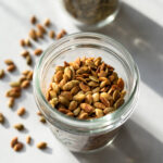 close up showing color and texture of roasted pumpkin seeds in a jar
