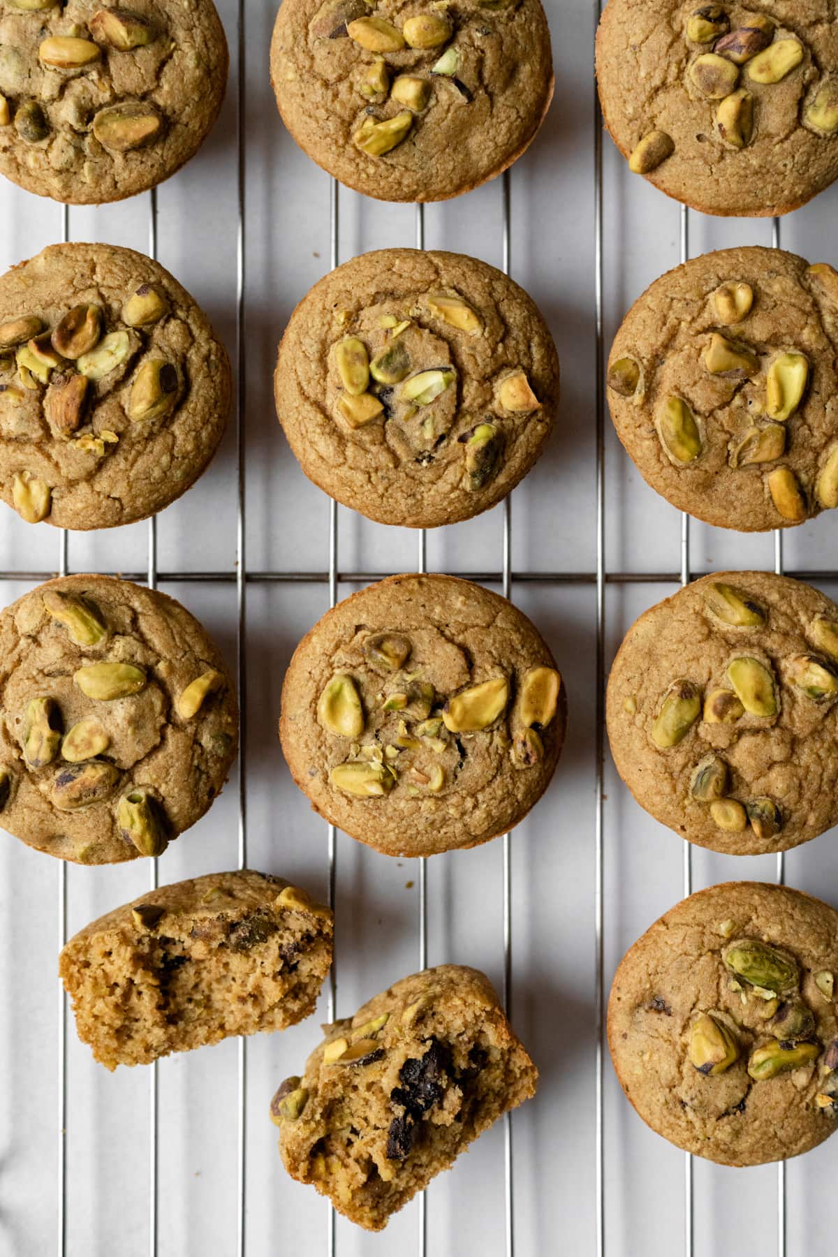 looking down at pistachio muffins on a cooling rack.