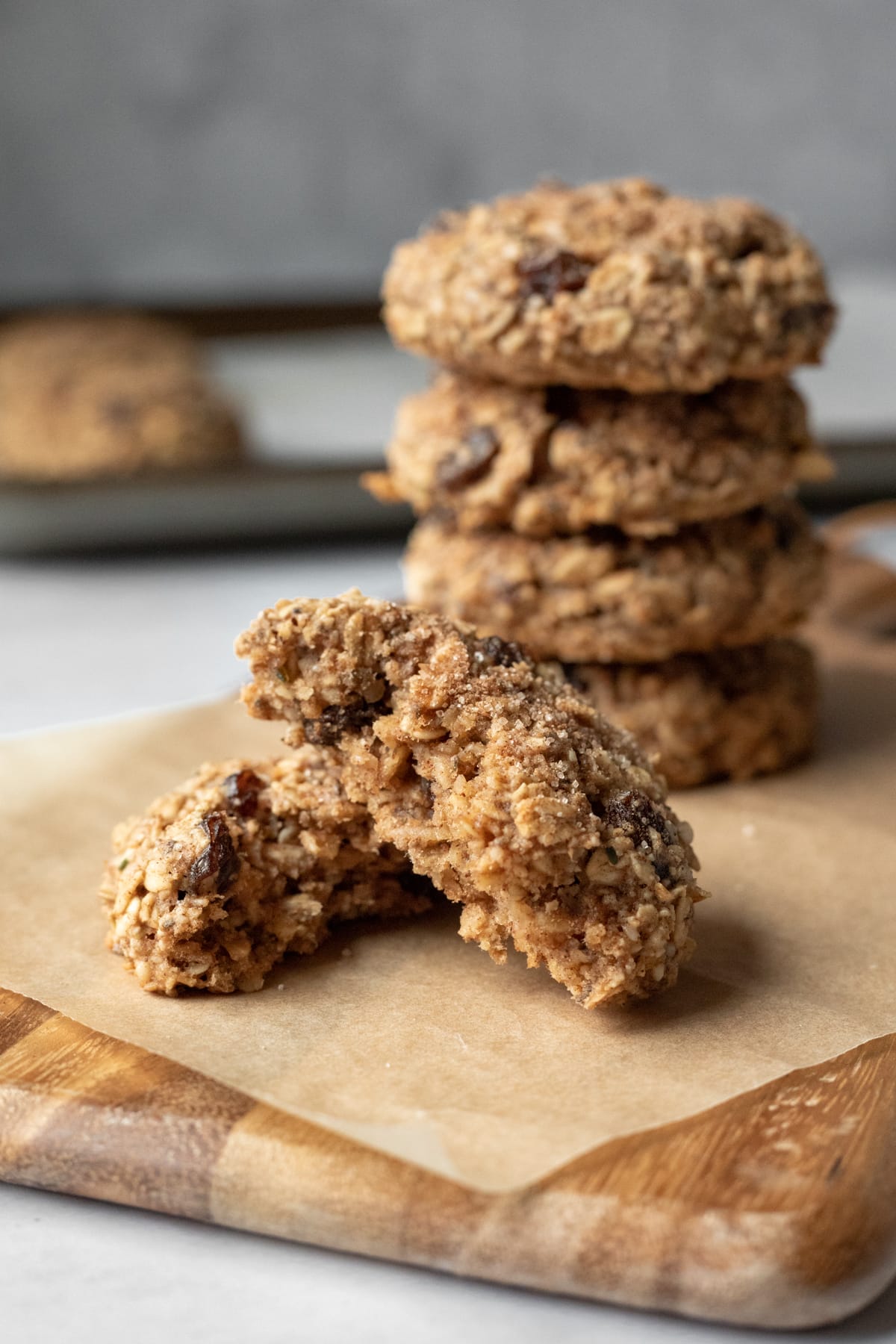 cookie broken in half to show chewy oats, raisins, and cinnamon inside.