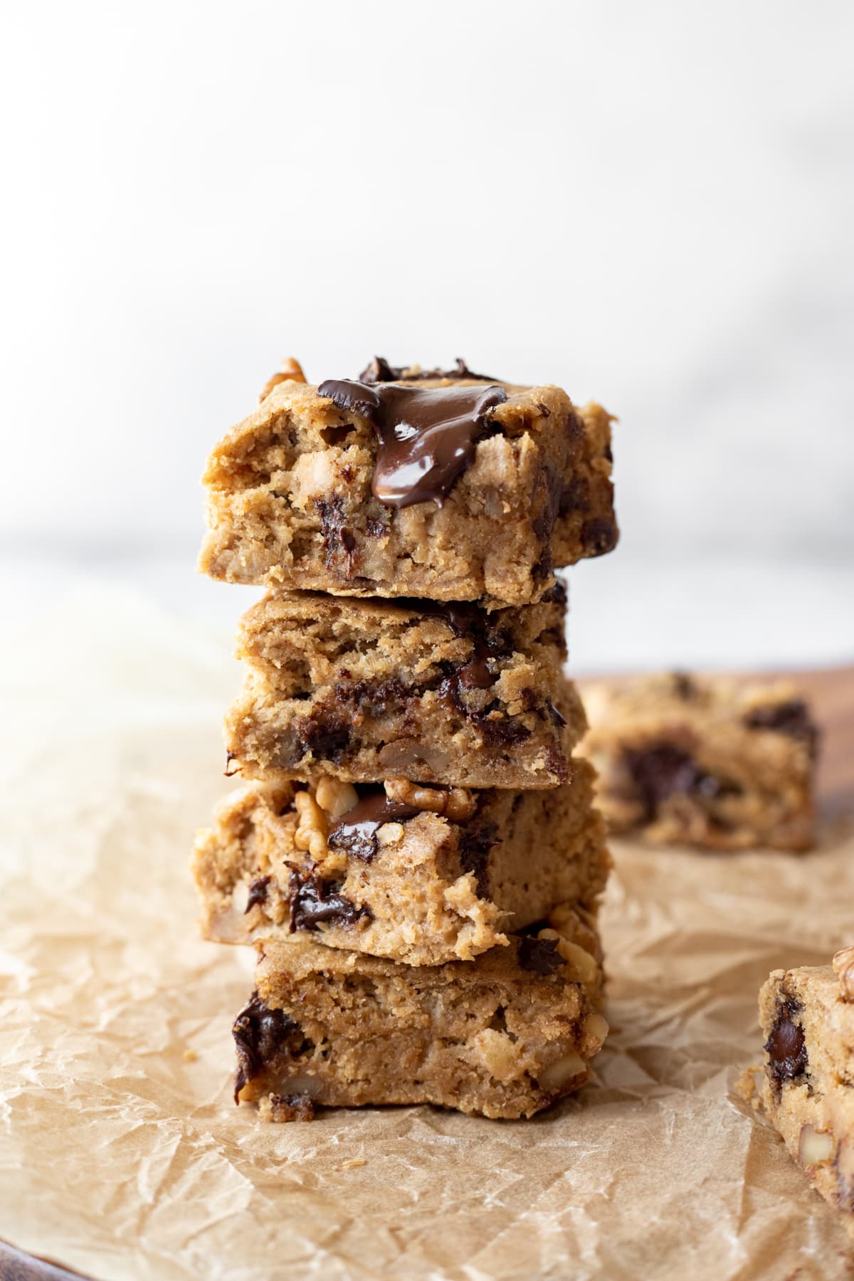 4 banana blondies stacked against white background