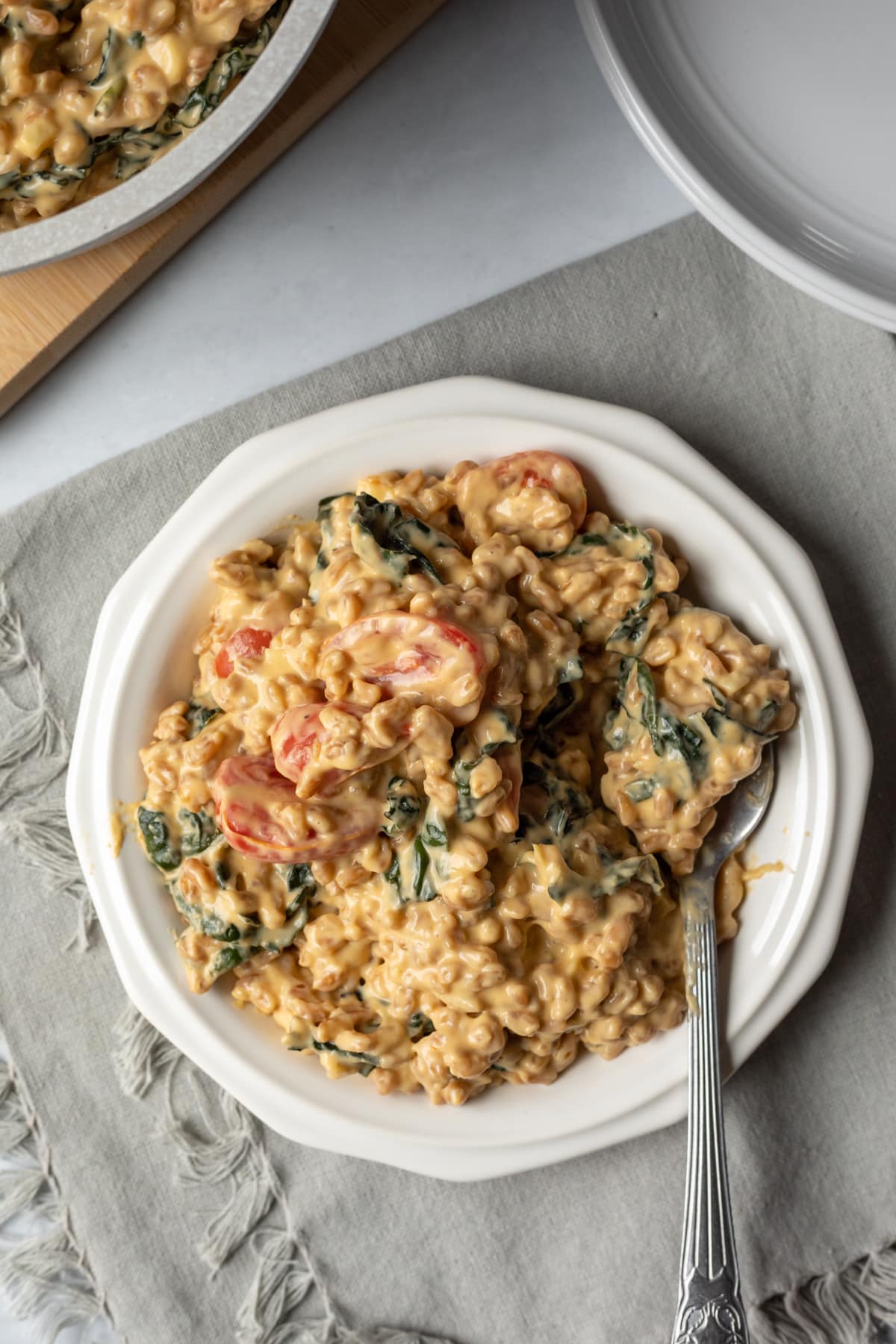 serving of creamy farro on a small white plate