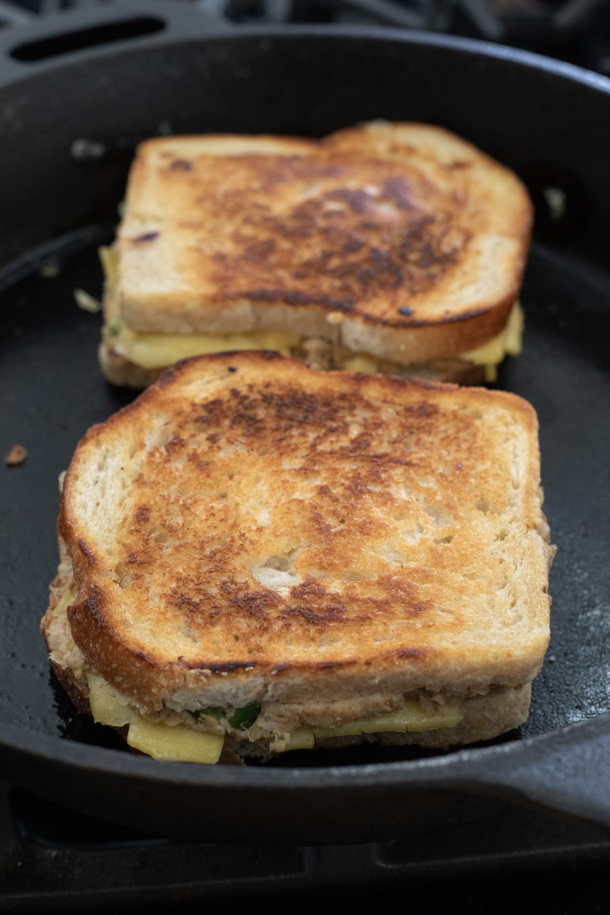 two sandwiches in a cast iron pan
