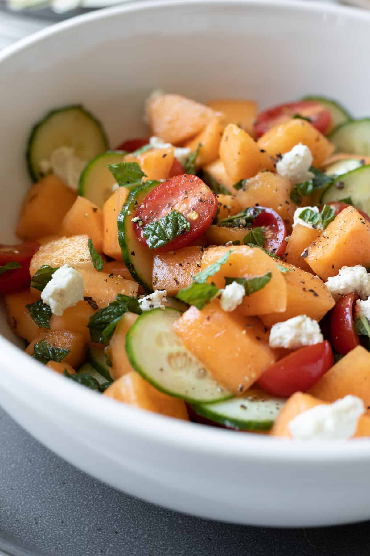 photo of salad in large serving bowl, topped with chopped mint.