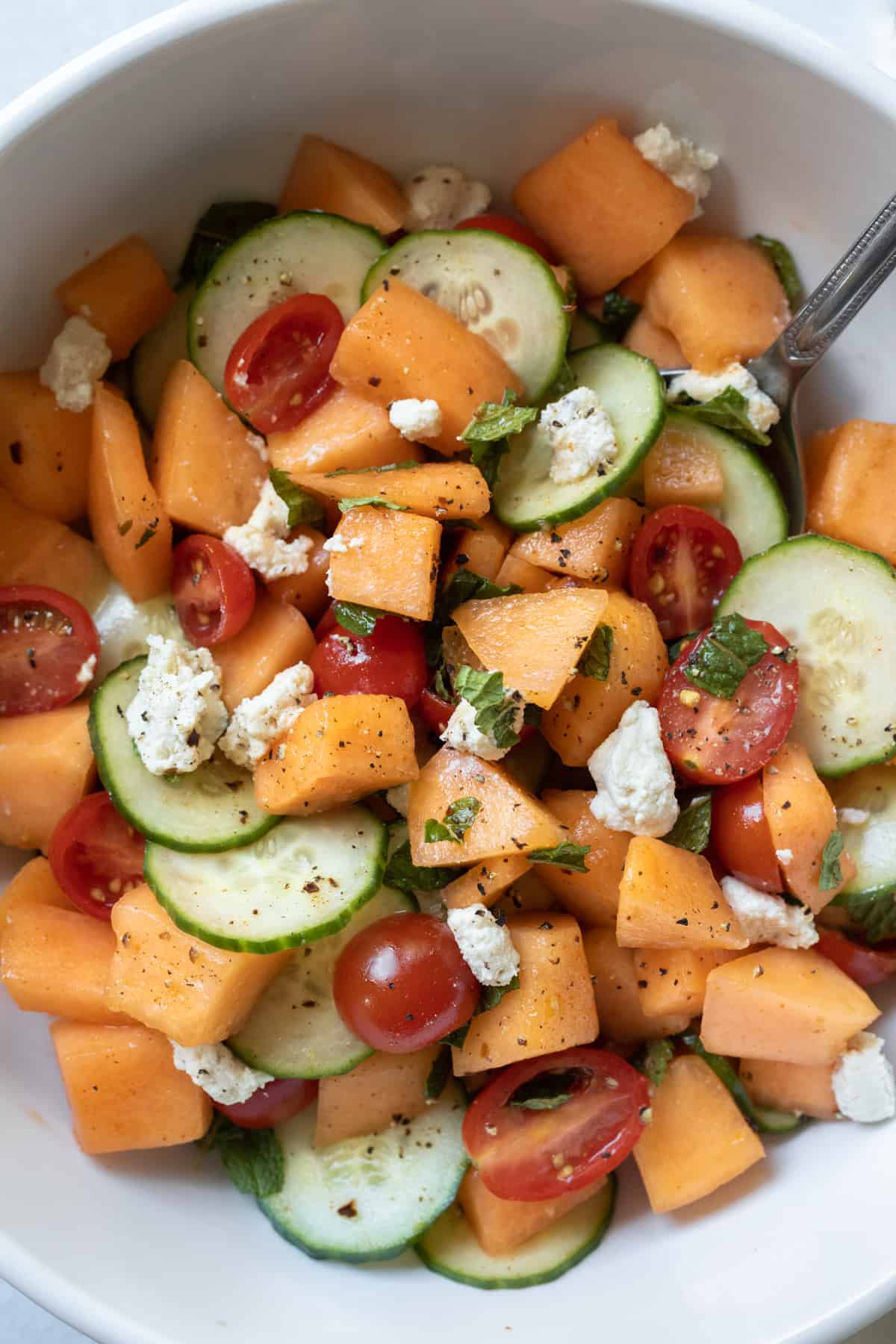 closeup overhead of salad in white bowl showing all ingredients.