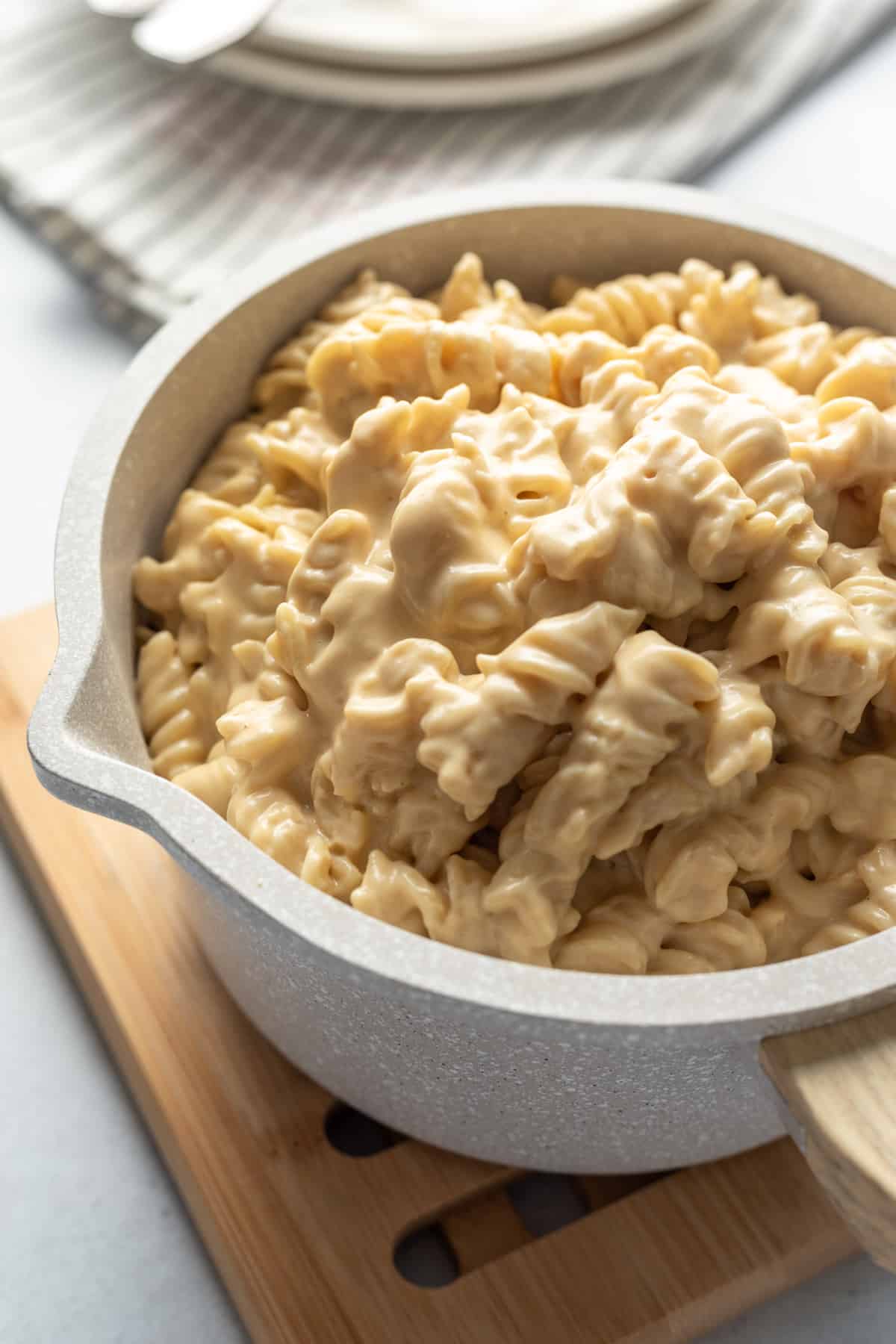 small pot full of fusilli pasta covered in a very creamy nut-free dairy-free cheese sauce