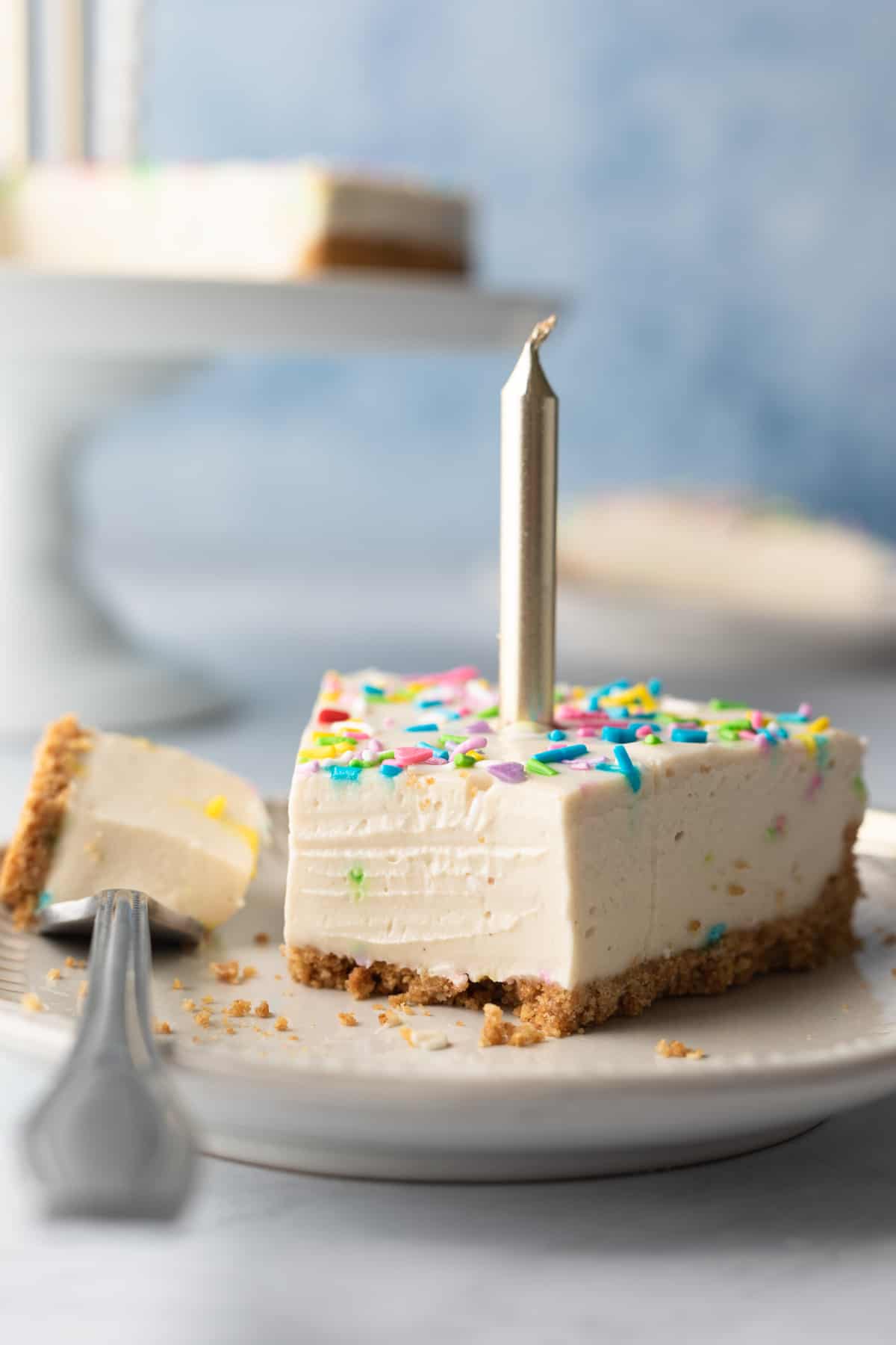 close up of creamy texture with a bite of cheesecake resting on a fork